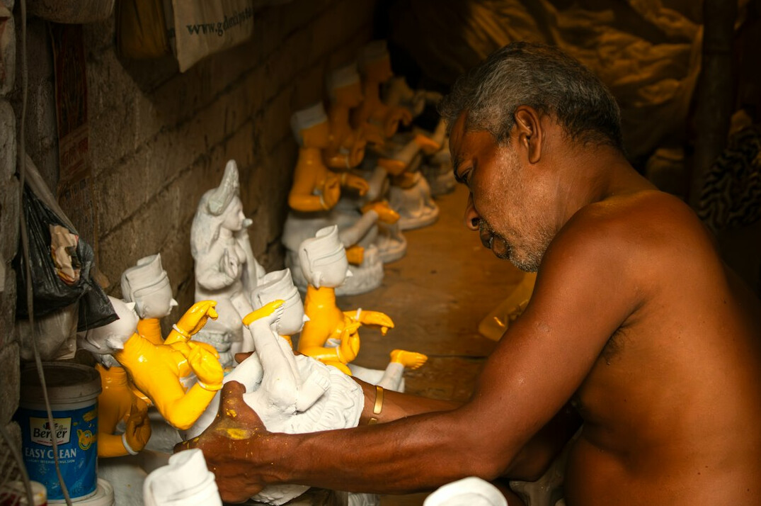 Smiling male auto body painter in a workshop